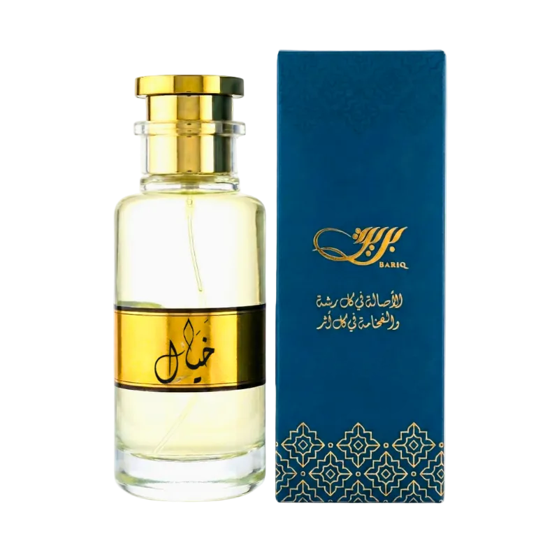 Perfume bottle with gold cap and label next to a blue box with gold design on a white background
